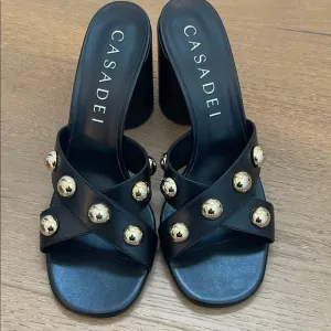 Casadei Black and Gold Mules with Studded Detail