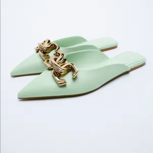 FLAT MULES WITH BUCKLE DETAIL