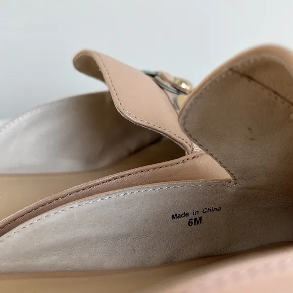 Kate Spade “Carilee” leather mules with flower detail