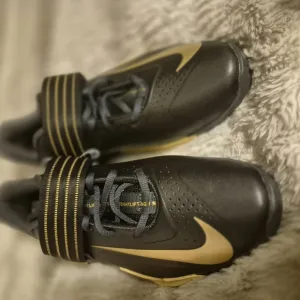 Nike Black and Gold Athletic Shoes with Textured Upper